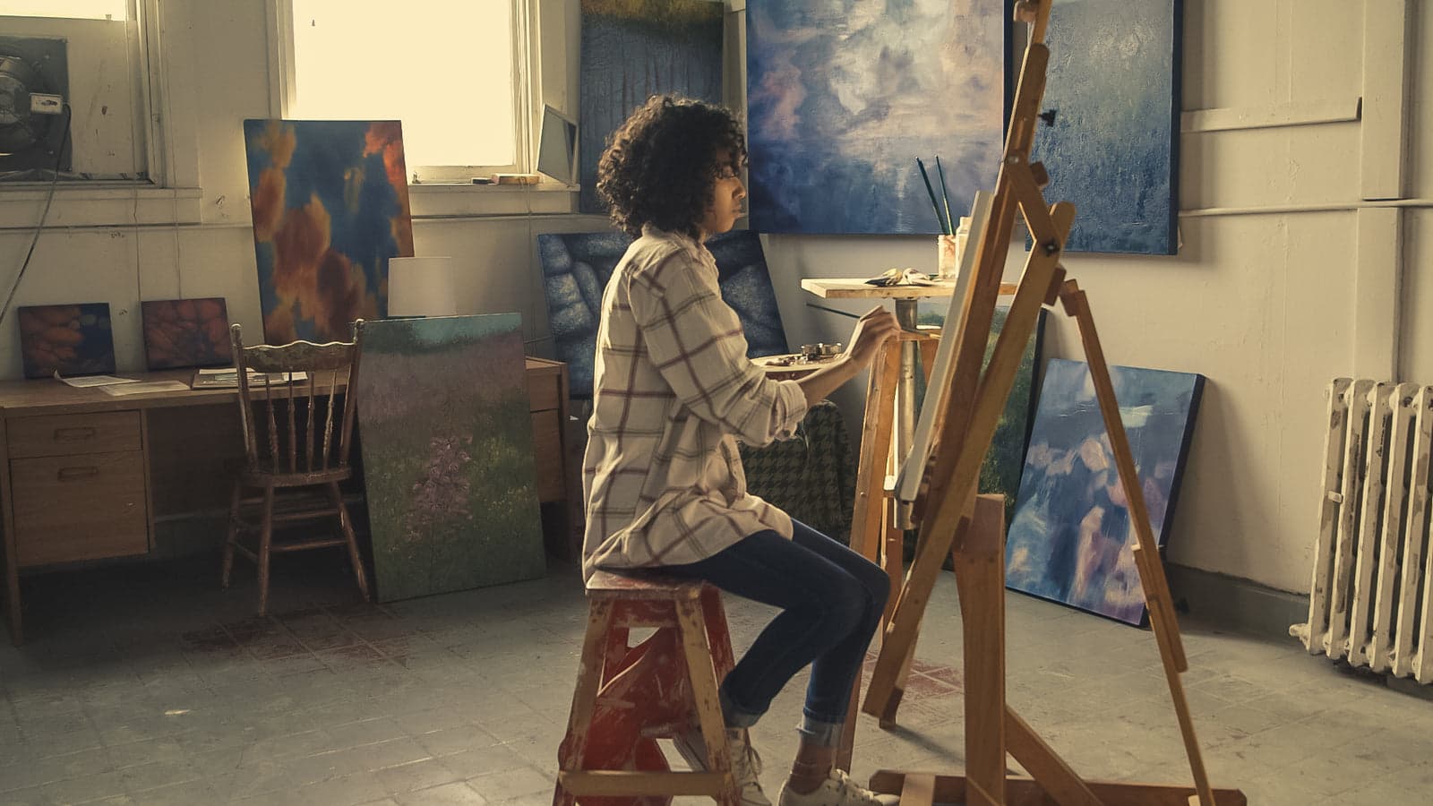 Artist working in a sunlit studio